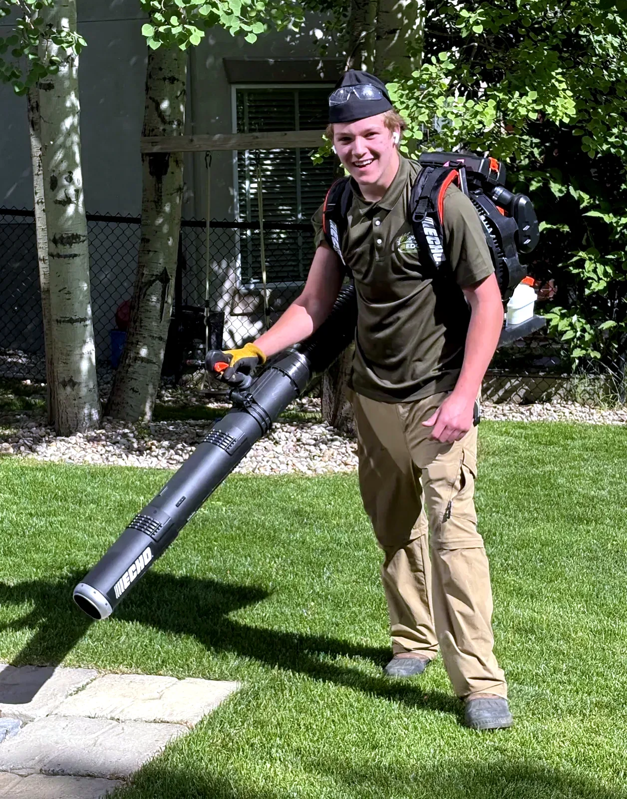 Kavin Alexander, founder of Edge Property Services, with backpack blower on a freshly cut Calgary lawn