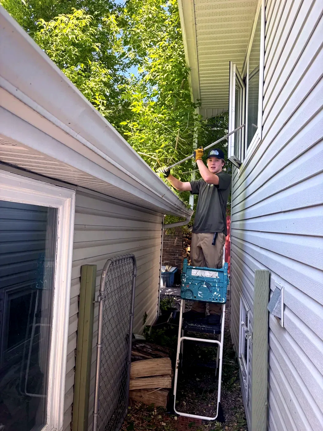 Kavin pruning overhanging branches between homes — Edge Property Services Calgary