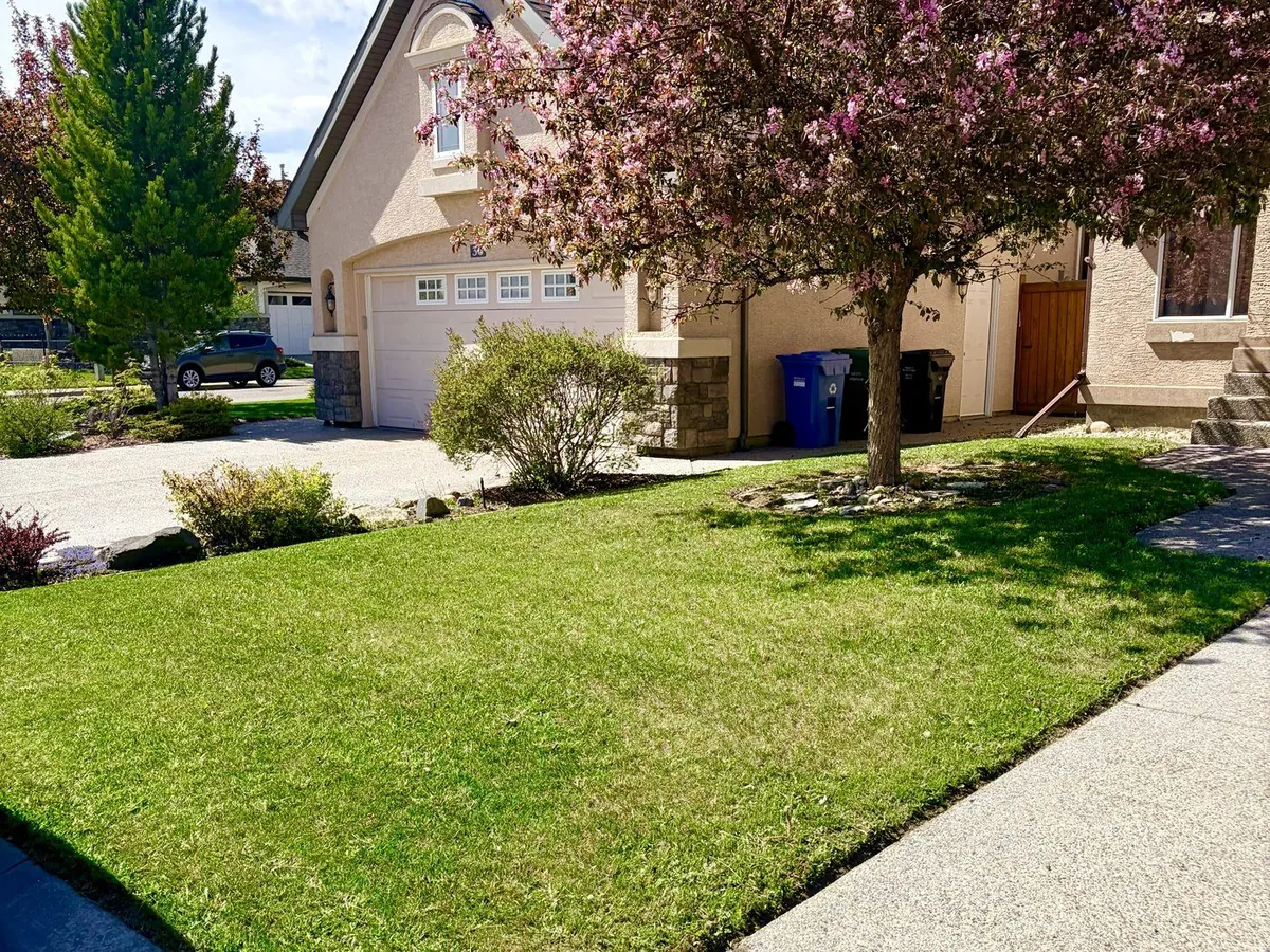 Lush manicured Calgary lawn after maintenance — Edge Property Services